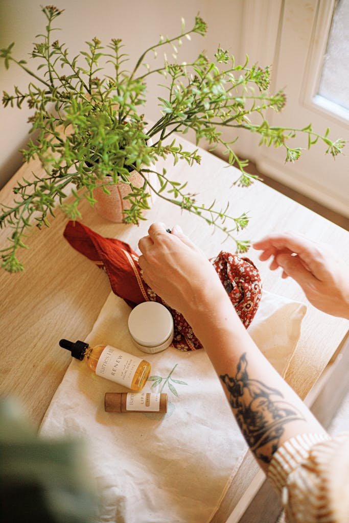 Artistic flat lay of natural skincare products with plants, showcasing a serene spa atmosphere.