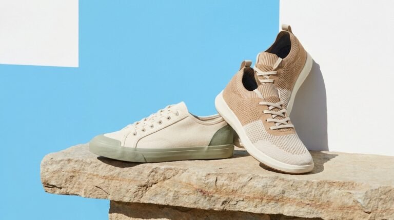 Sustainable sneakers in natural and earth tones on a stone ledge against a bold color-blocked background